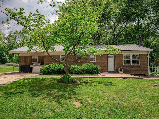 11219 Denzer Rd, Evansville, IN 47712 - single story home with a front lawn, metal roof, and brick siding