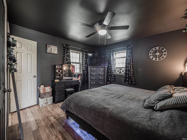 11219 Denzer Rd, Evansville, IN 47712 - bedroom with wood finished floors, multiple windows, and ceiling fan