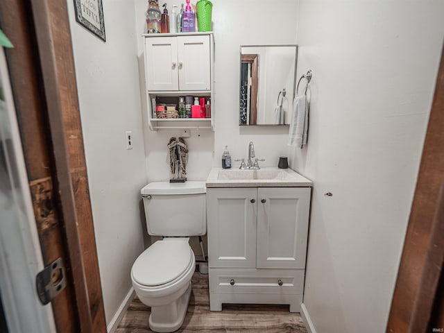 11219 Denzer Rd, Evansville, IN 47712 - bathroom with toilet, wood finished floors, vanity, and baseboards
