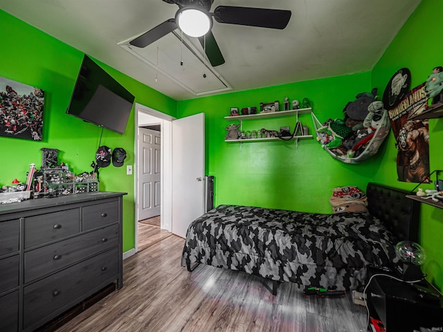 11219 Denzer Rd, Evansville, IN 47712 - bedroom featuring attic access, wood finished floors, and a ceiling fan