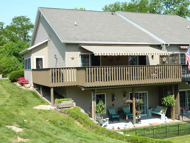 2508 N Stonelake Dr, Bloomington, IN 47404 - back of property featuring a deck, a patio, and a shingled roof