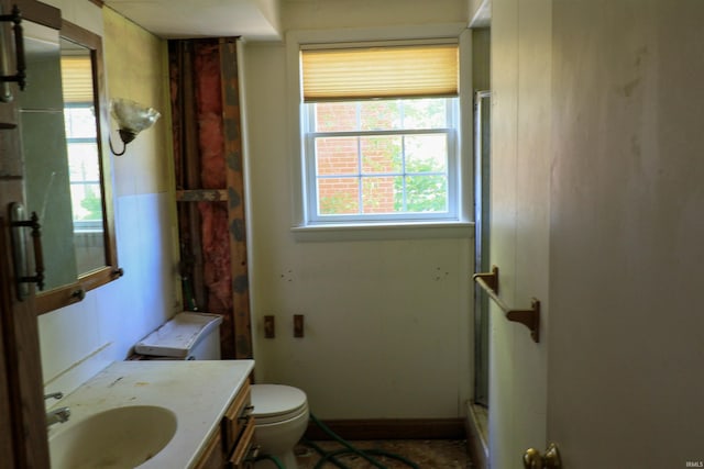 802 Hasenour Ave, Jasper, IN 47546 - bathroom featuring a shower with shower door, vanity, and toilet