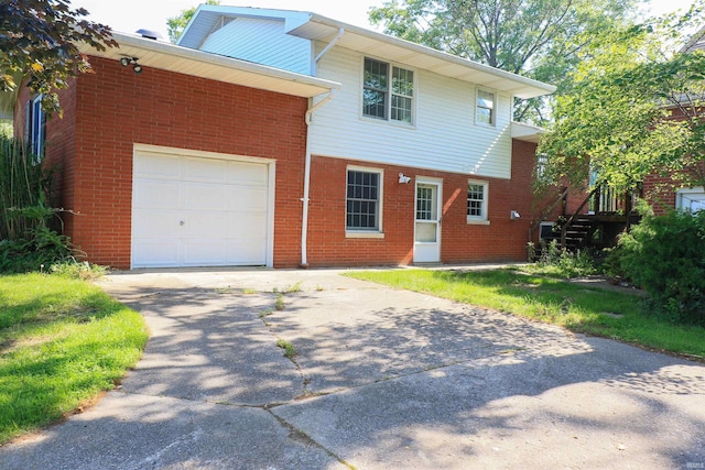 802 Hasenour Ave, Jasper, IN 47546 - view of front facade featuring concrete driveway, brick siding, and a garage
