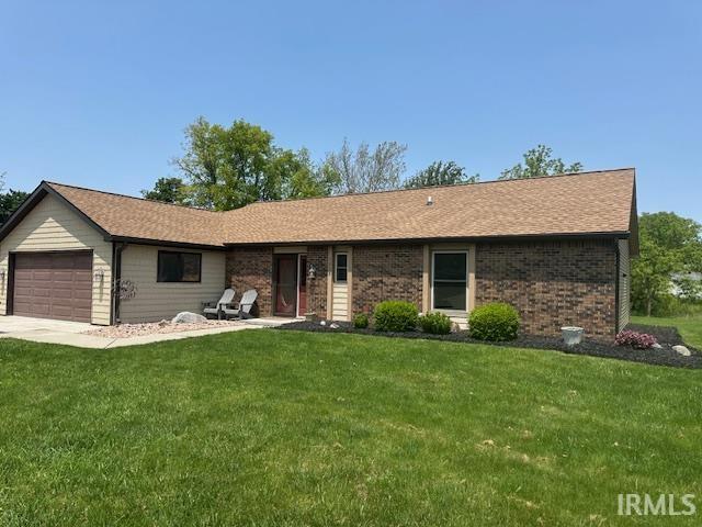 7025 Elmbrook Dr, Fort Wayne, IN 46835 - ranch-style home with a front yard, an attached garage, brick siding, and a shingled roof