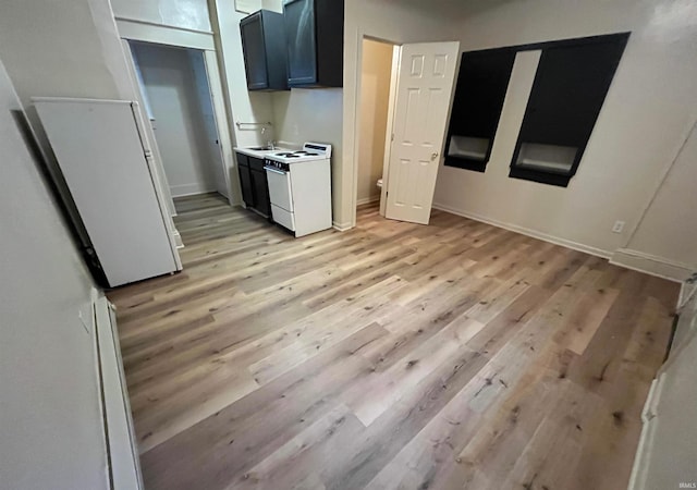 2130 Broadway, Fort Wayne, IN 46802 - kitchen featuring electric stove, light wood-style flooring, light countertops, and baseboards