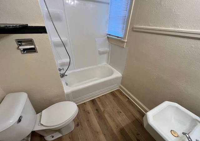 2130 Broadway, Fort Wayne, IN 46802 - full bath featuring a textured wall, toilet, wood finished floors, washtub / shower combination, and baseboards