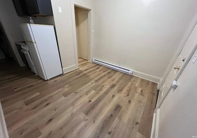 2130 Broadway, Fort Wayne, IN 46802 - unfurnished dining area featuring a baseboard radiator, wood finished floors, and baseboards