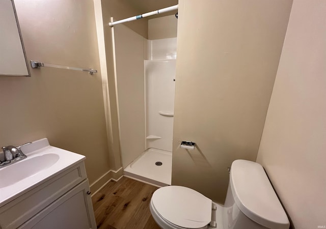2130 Broadway, Fort Wayne, IN 46802 - bathroom featuring wood finished floors, a shower stall, toilet, vanity, and baseboards