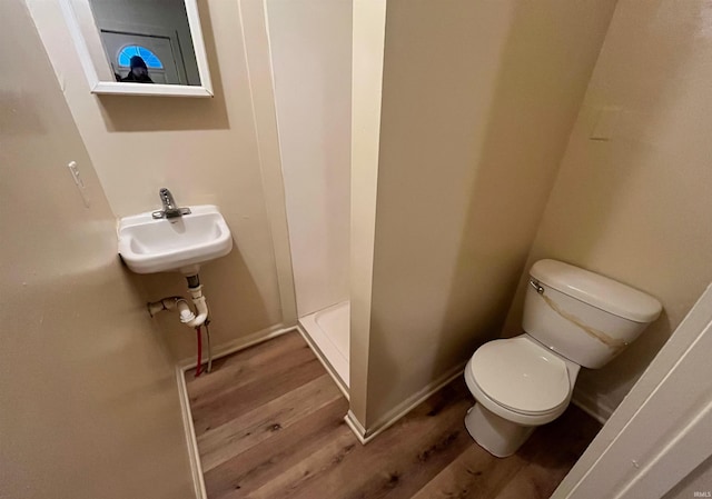 2130 Broadway, Fort Wayne, IN 46802 - full bathroom featuring wood finished floors, a shower stall, toilet, a sink, and baseboards