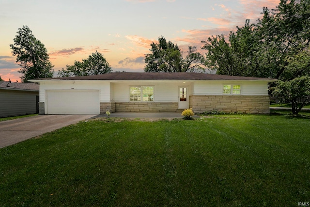 2604 Bellevue Dr, Fort Wayne, IN 46825 - view of front of home with an attached garage, a front lawn, concrete driveway, and stone siding