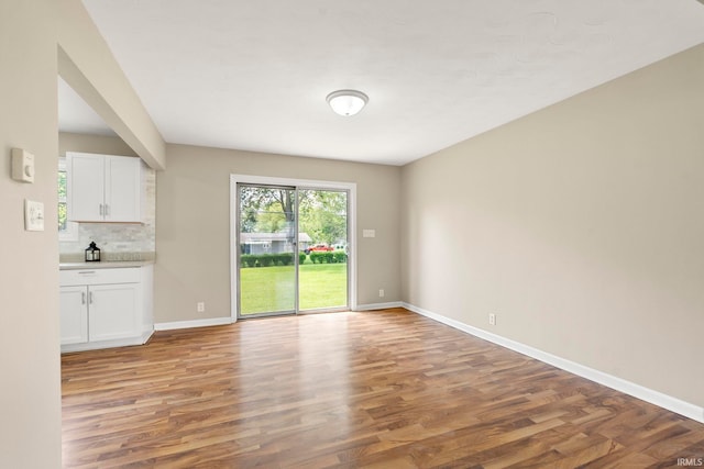2604 Bellevue Dr, Fort Wayne, IN 46825 - unfurnished living room with light wood-style flooring and baseboards