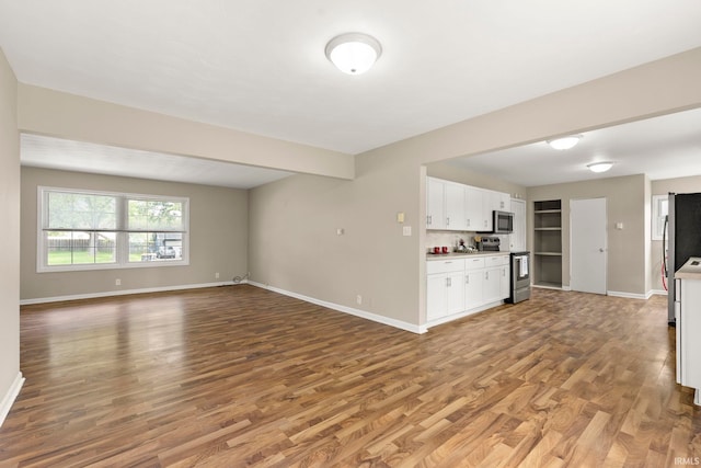 2604 Bellevue Dr, Fort Wayne, IN 46825 - unfurnished living room featuring light wood-style flooring and baseboards