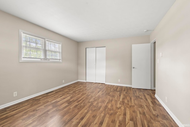 2604 Bellevue Dr, Fort Wayne, IN 46825 - unfurnished bedroom featuring wood finished floors, baseboards, and a closet