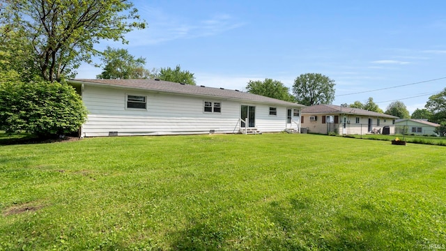 2604 Bellevue Dr, Fort Wayne, IN 46825 - rear view of house with entry steps and a yard