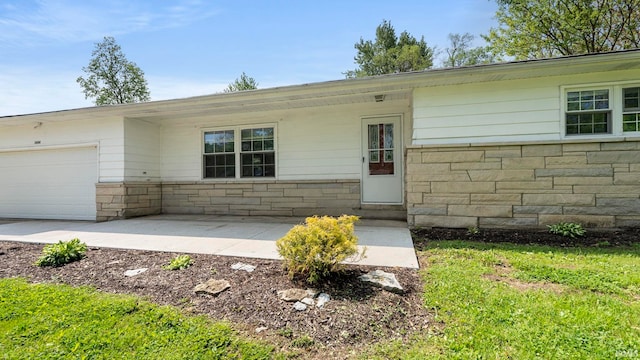 2604 Bellevue Dr, Fort Wayne, IN 46825 - view of front of home with an attached garage and stone siding