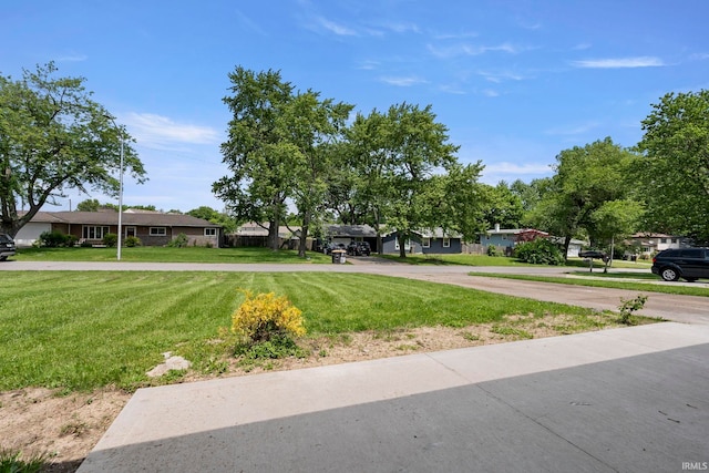 2604 Bellevue Dr, Fort Wayne, IN 46825 - view of green lawn with driveway and a residential view
