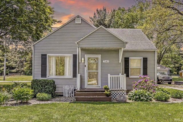 542 E Michigan St, New Carlisle, IN 46552 - bungalow-style home featuring a yard and a shingled roof