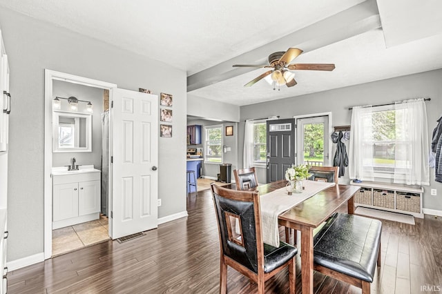 542 E Michigan St, New Carlisle, IN 46552 - dining space featuring wood finished floors, a ceiling fan, and baseboards
