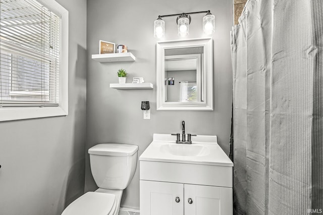 542 E Michigan St, New Carlisle, IN 46552 - bathroom featuring toilet, healthy amount of natural light, vanity, and a shower with curtain