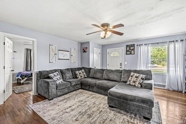 542 E Michigan St, New Carlisle, IN 46552 - living room featuring a ceiling fan, a textured ceiling, wood finished floors, and baseboards