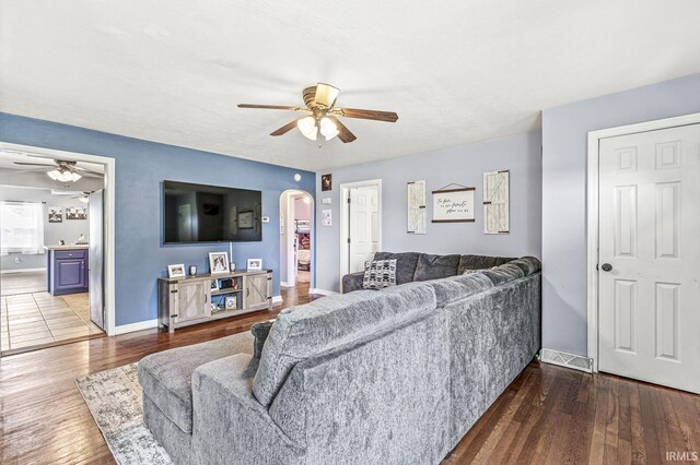 542 E Michigan St, New Carlisle, IN 46552 - living area with a ceiling fan, arched walkways, wood finished floors, and baseboards