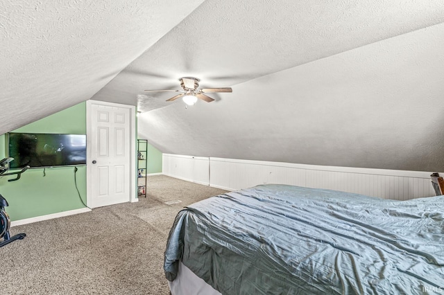 542 E Michigan St, New Carlisle, IN 46552 - carpeted bedroom with a textured ceiling, vaulted ceiling, a ceiling fan, and baseboards