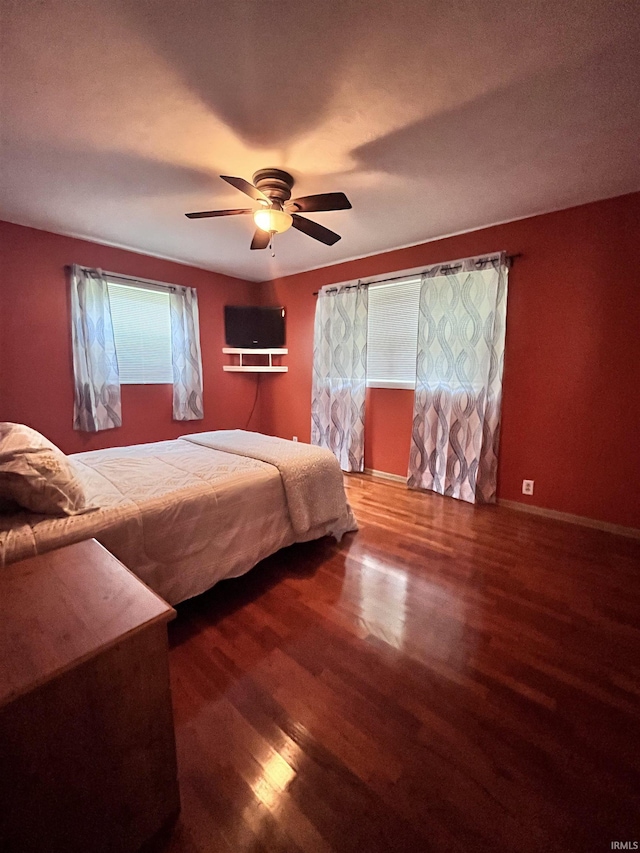 503 Laura Ln, Sweetser, IN 46987 - bedroom featuring wood finished floors, ceiling fan, and baseboards
