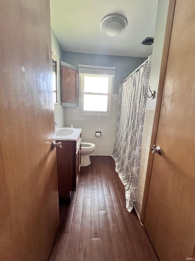 503 Laura Ln, Sweetser, IN 46987 - bathroom with vanity, wood finished floors, toilet, tile walls, and a shower with shower curtain