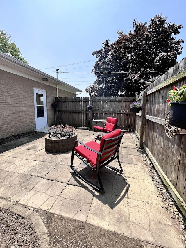 503 Laura Ln, Sweetser, IN 46987 - fenced backyard featuring a fire pit and a patio area
