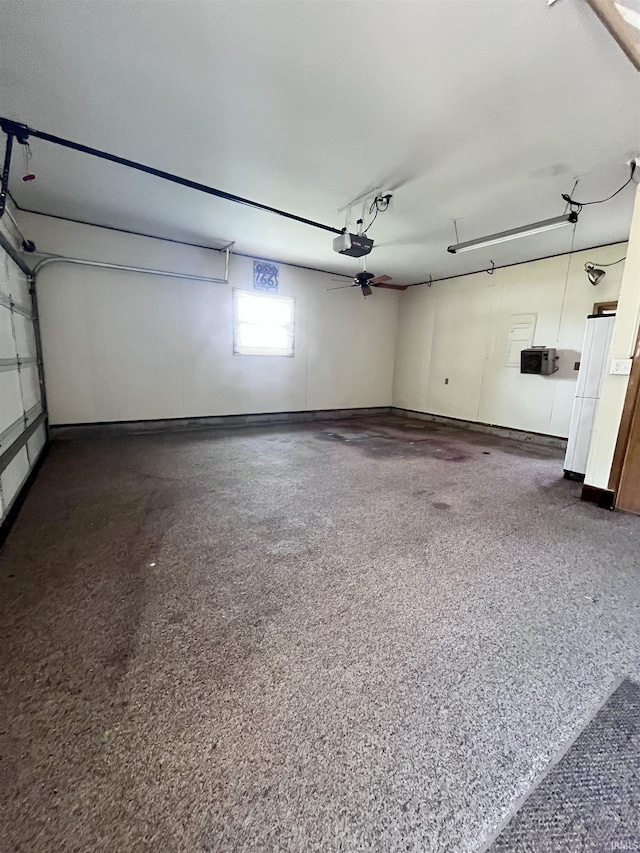 503 Laura Ln, Sweetser, IN 46987 - garage with a garage door opener, freestanding refrigerator, and baseboards