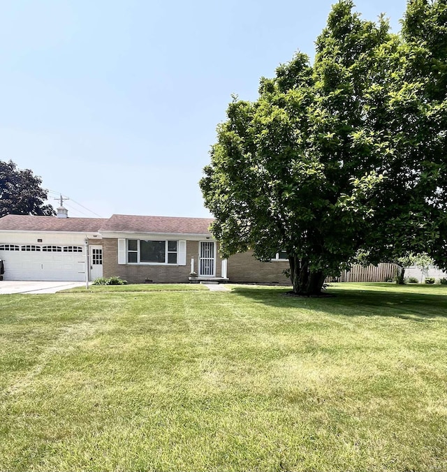 503 Laura Ln, Sweetser, IN 46987 - view of front of home featuring a garage, brick siding, and driveway