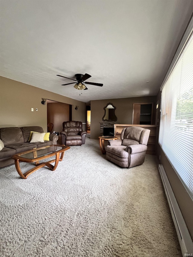 503 Laura Ln, Sweetser, IN 46987 - living area featuring baseboard heating, carpet flooring, and a ceiling fan