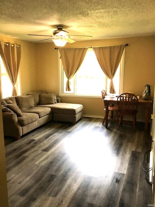 449 Cline St, Huntington, IN 46750 - living room featuring a ceiling fan, a textured ceiling, and dark wood-style floors