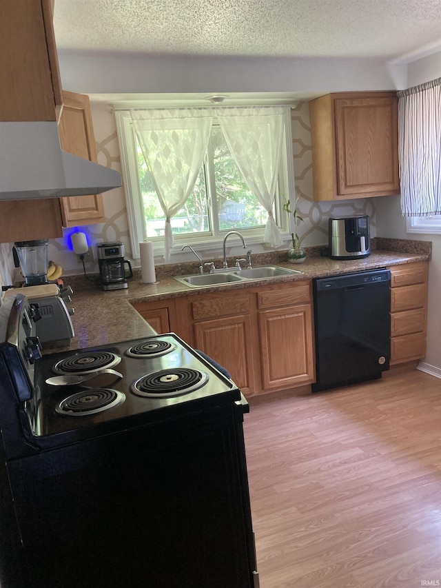 449 Cline St, Huntington, IN 46750 - kitchen featuring black appliances, a sink, a textured ceiling, ventilation hood, and light wood-style floors