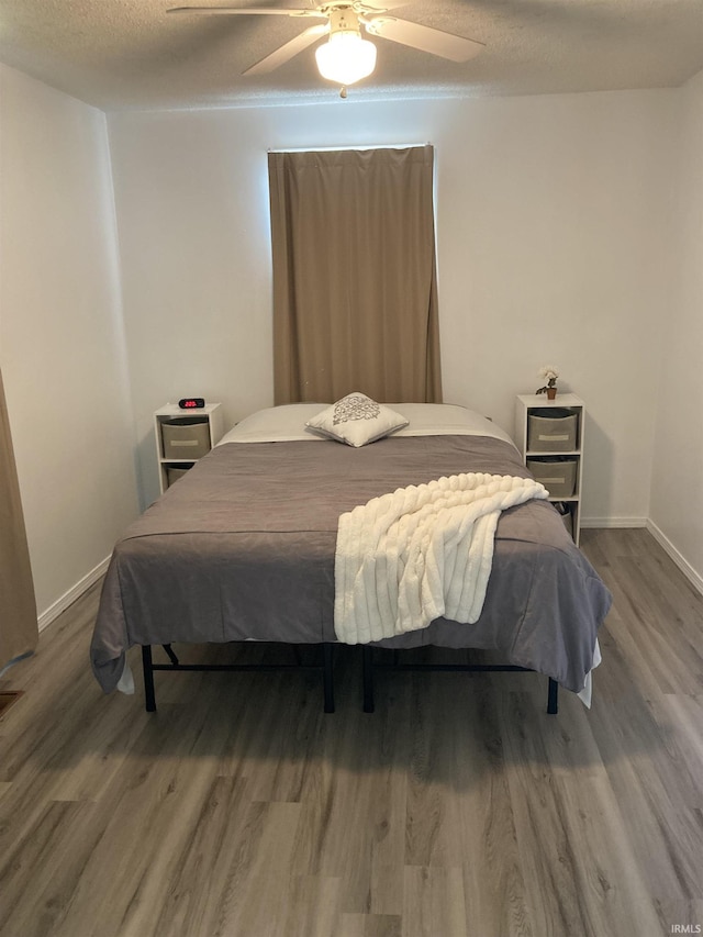 449 Cline St, Huntington, IN 46750 - bedroom with wood finished floors, a ceiling fan, baseboards, and a textured ceiling