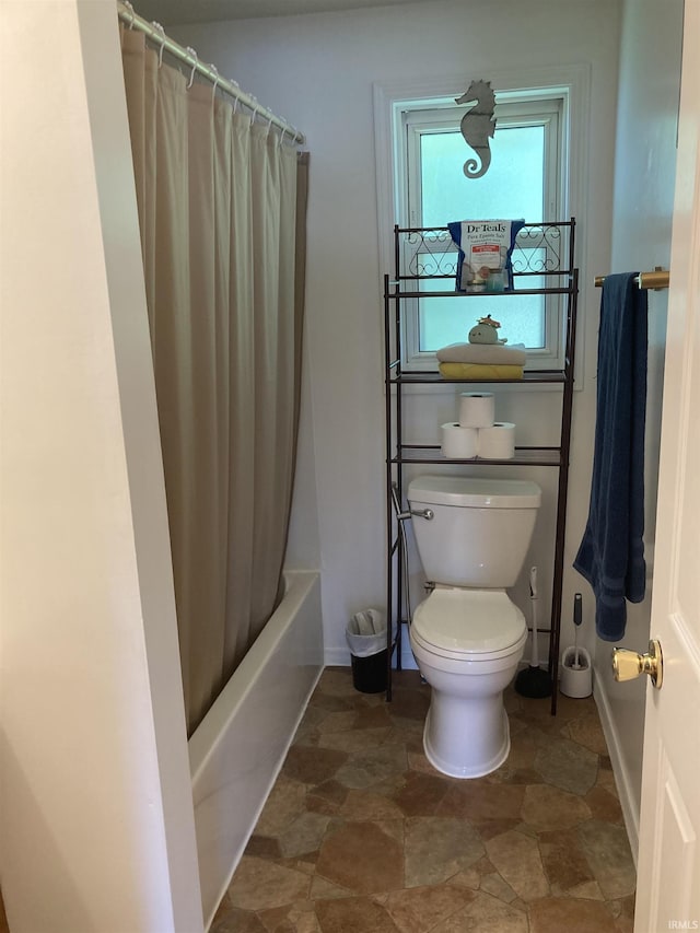 449 Cline St, Huntington, IN 46750 - bathroom featuring baseboards, toilet, shower / tub combo with curtain, and stone finish floors