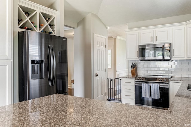 210 Meadows Dr, Greentown, IN 46936 - kitchen with stainless steel appliances, white cabinetry, tasteful backsplash, and stone counters