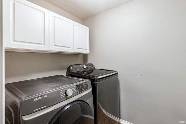 210 Meadows Dr, Greentown, IN 46936 - laundry room featuring cabinet space, washer and clothes dryer, and a textured ceiling