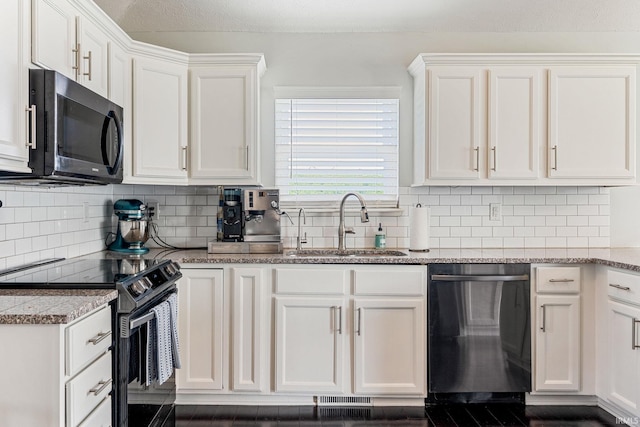 210 Meadows Dr, Greentown, IN 46936 - kitchen with black appliances, a sink, white cabinets, and light stone counters