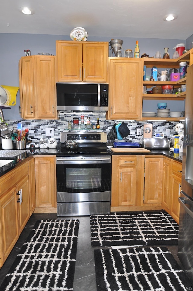 1502 S College Ave, Bloomington, IN 47403 - kitchen with appliances with stainless steel finishes, tasteful backsplash, and dark countertops