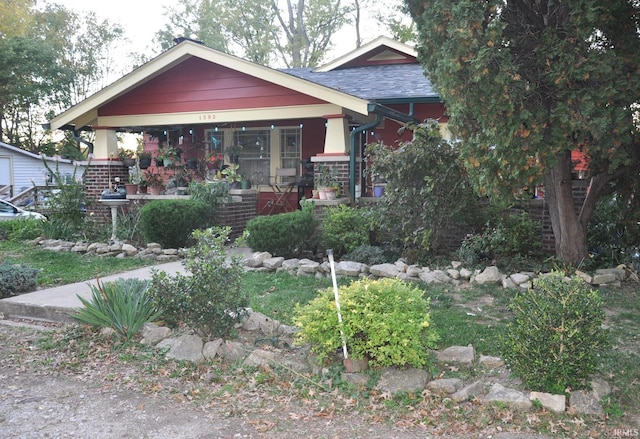 1502 S College Ave, Bloomington, IN 47403 - craftsman house with a porch and brick siding