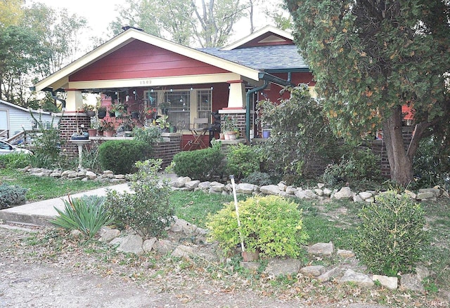 1502 S College Ave, Bloomington, IN 47403 - view of front of home featuring a porch and roof with shingles