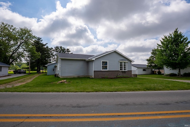 1339 Clark Ave, Bluffton, IN 46714 - view of front facade with a front yard, brick siding, and driveway