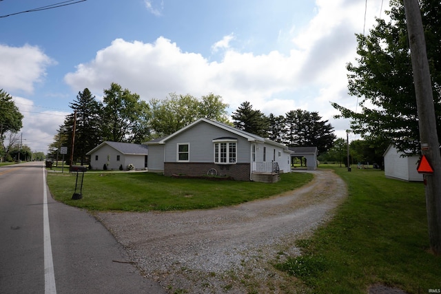 1339 Clark Ave, Bluffton, IN 46714 - view of front of home with driveway, a front yard, and brick siding