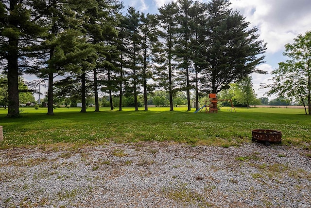 1339 Clark Ave, Bluffton, IN 46714 - view of grassy yard with a playground and an outdoor fire pit