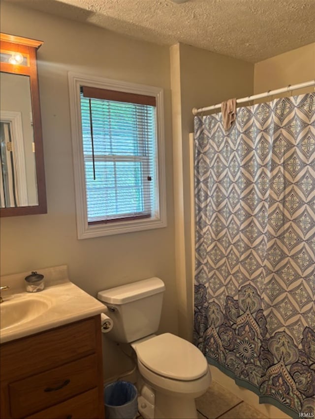 999 Inderrieden Rd, Chandler, IN 47610 - full bathroom with vanity, toilet, tile patterned floors, a textured ceiling, and curtained shower