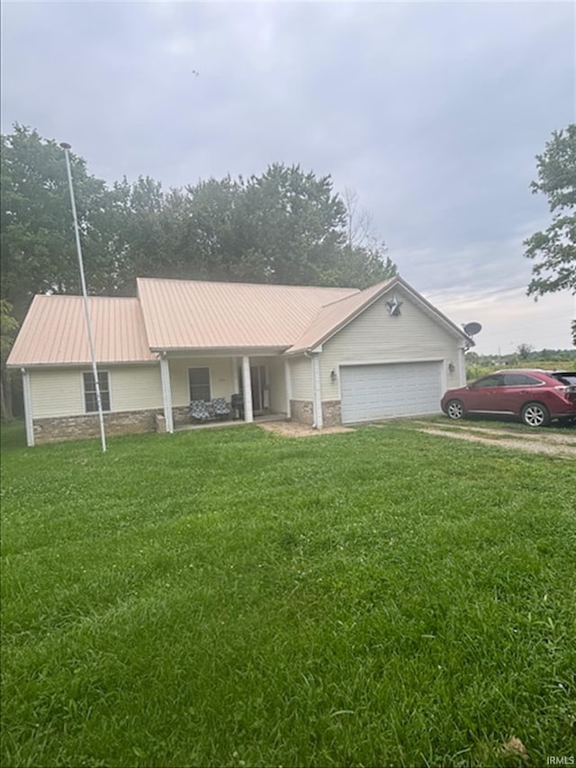 999 Inderrieden Rd, Chandler, IN 47610 - ranch-style home featuring a front lawn, a garage, metal roof, driveway, and stone siding