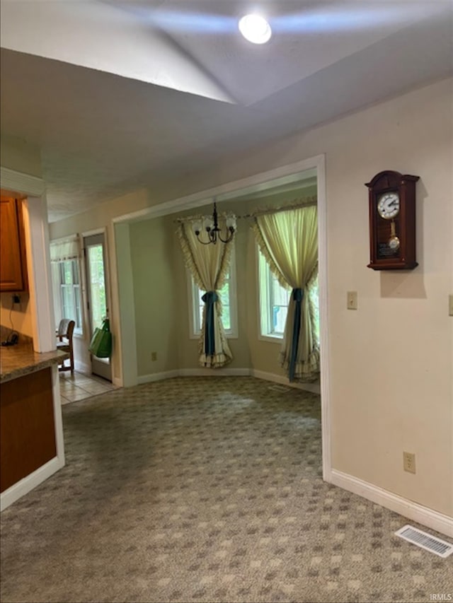 999 Inderrieden Rd, Chandler, IN 47610 - unfurnished dining area featuring a chandelier, healthy amount of natural light, and light carpet