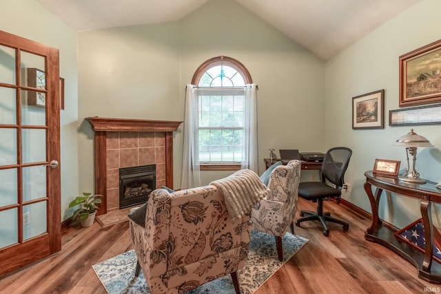 5003 N Chatham Dr, Bloomington, IN 47404 - office space with vaulted ceiling, wood finished floors, a tile fireplace, and baseboards