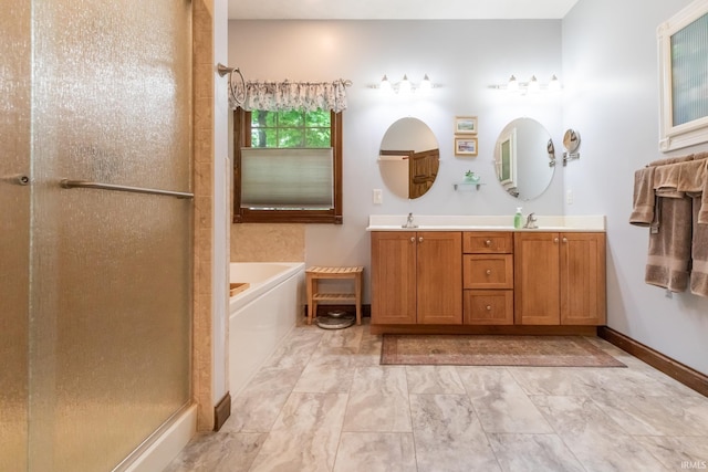 5003 N Chatham Dr, Bloomington, IN 47404 - bathroom with double vanity, a stall shower, a garden tub, baseboards, and marble look tiles